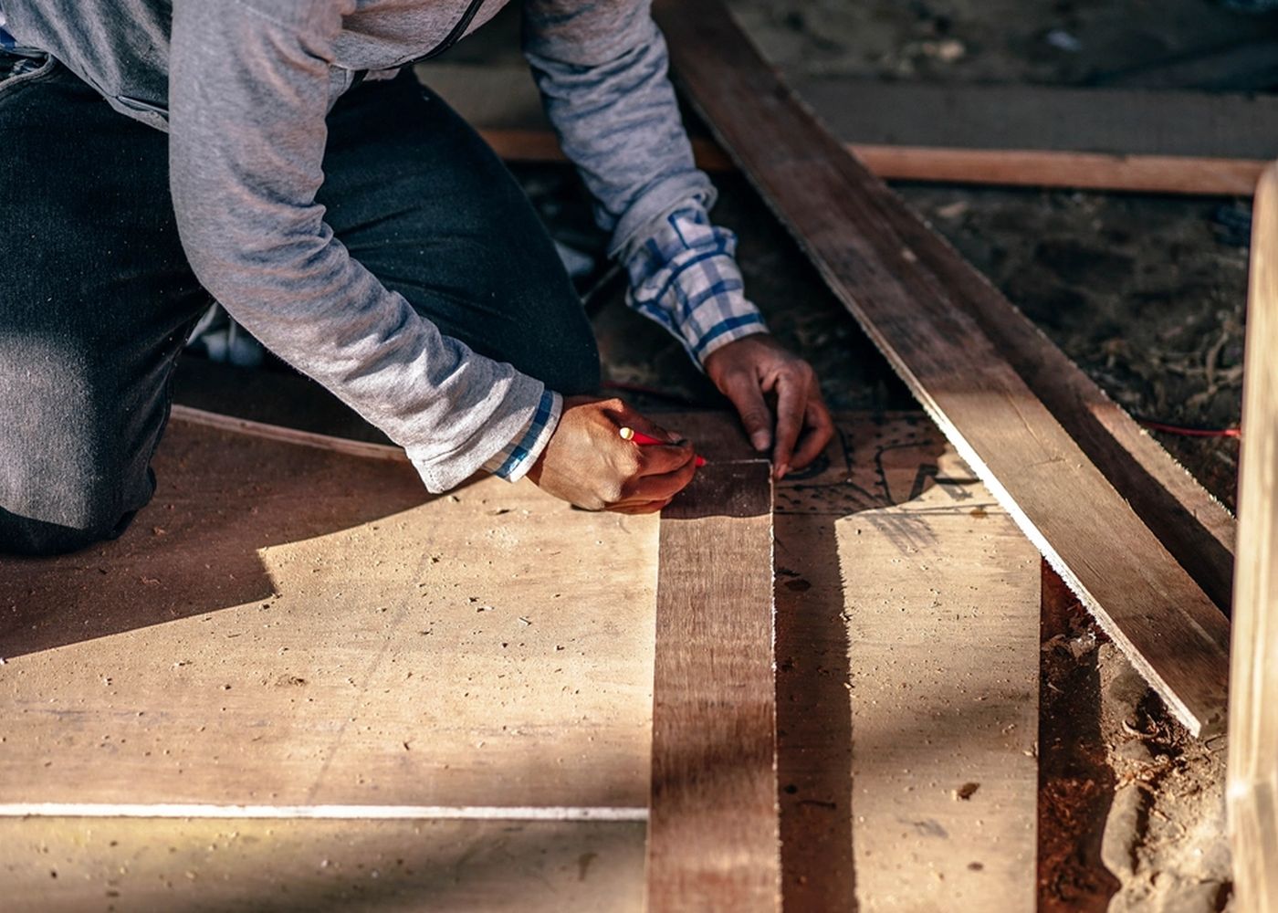 Contractor measuring and cutting deck boards